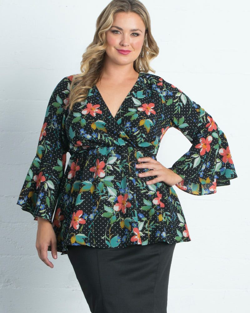 Front of a model wearing a size 0X Ava Bell-Sleeve Faux-Wrap Top in POPPY POLKA DOTS by Kiyonna. | dia_product_style_image_id:227577